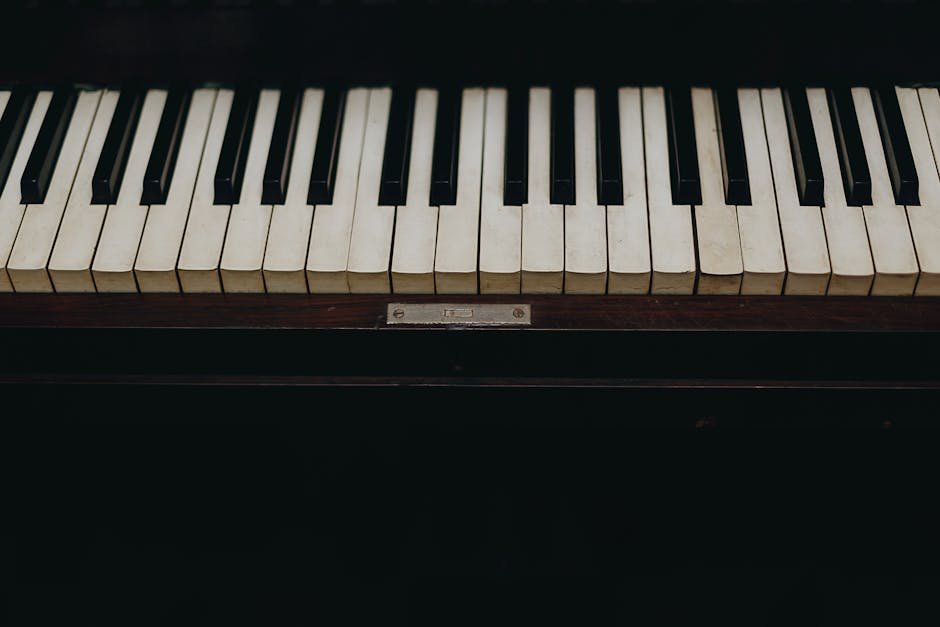 A close-up view of vintage piano keys showcasing the wear and character of the instrument.